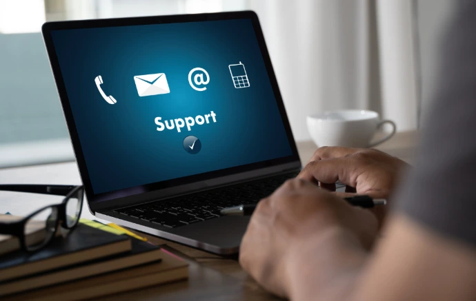 Digital support icons floating over a laptop representing Odoo customer assistance.